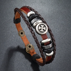 Retro multi-layer cross leather bracelet with woven rope and metal charms in 45-degree view