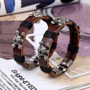 Retro genuine leather bracelet set with metallic skull charms and braided black cords