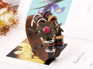 Detail of vintage bohemian leather bracelet with colorful wood beads and metal charms