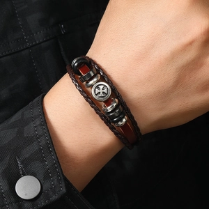 Retro multi-layer braided leather bracelet featuring a vintage iron cross charm on the wrist