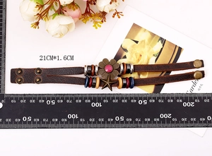 Detail of vintage braided leather bracelet with floral charm and metallic snap buttons