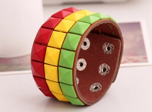 Macro view of adjustable punk leather bracelet featuring red yellow green pyramid studs