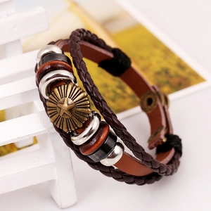 Retro multi-layer leather bracelet with star metal charms and braided cords on wood base