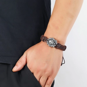 Men's retro braided leather bracelet featuring a detailed silver lion head charm
