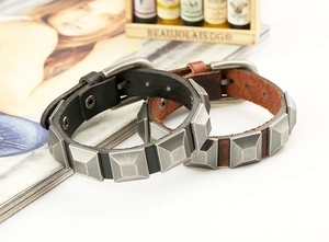 Close-up of vintage punk leather bracelets with square metal studs and buckle closure