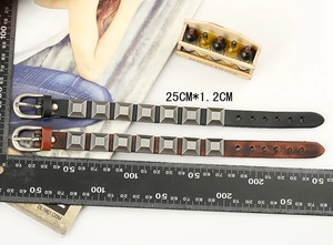 Detailed size view of studded leather bracelets in black and brown with scale measurement