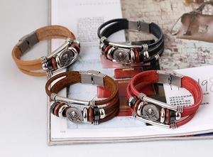Detail of multilayer leather bracelets with skull pirate charms and vintage beads