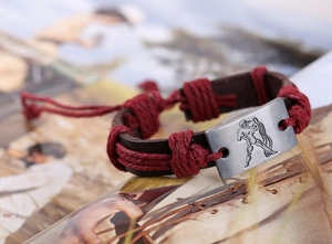 Macro detail of Aquarius vintage leather bracelet with engraved silver metal plate