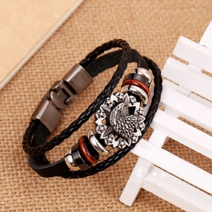 Handmade punk leather bracelet with eagle medallion and vintage woven design
