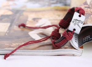 Detail of Aquarius zodiac sign vintage braided leather bracelet with adjustable cord