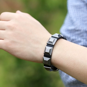 Punk style cowhide leather bracelet with four square pyramid metal studs on a wrist