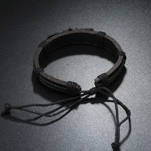Detailed view of woven black leather bracelet featuring adjustable nautical knot straps