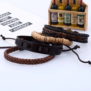 Detail of four-piece vintage braided leather bracelets with wood beads and metal eyelets