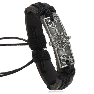 Handmade leather nautical bracelet with anchor and helm charms on white background