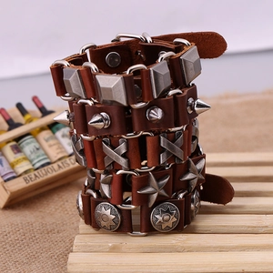 Detail of 5-piece brown leather punk bracelet set with metal studs and star charms