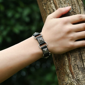 Men's punk leather bracelet with silver embossed metal squares and ring links on wrist