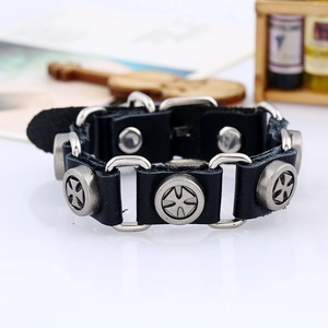 Detail of black leather punk bracelet featuring maltese cross studs and silver rings
