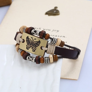 Handmade multilayer leather bracelet featuring a bronze butterfly charm and wooden beads