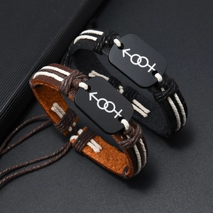 Vintage braided leather bracelets with gender symbols for couples on dark textured background