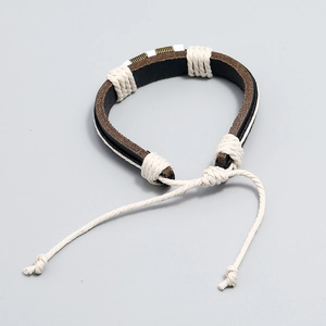 Detail of hand-woven leather bracelet featuring vintage spiral metal rings and cords