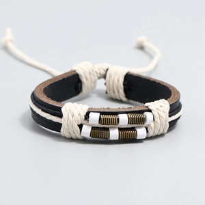 Detail of hand-woven leather bracelet with antique bronze beads and white ceramic accents