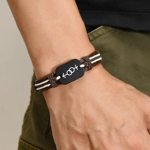 Retro brown leather woven bracelet with unisex symbol on a black metal plate