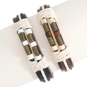 Close-up of bohemian multilayer braided leather bracelets with wood beads and metal rings