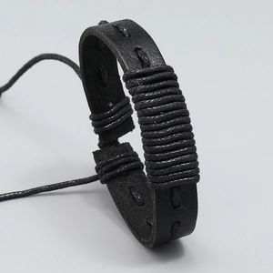 Handmade woven black leather bracelet with retro punk cord details and adjustable pull-string