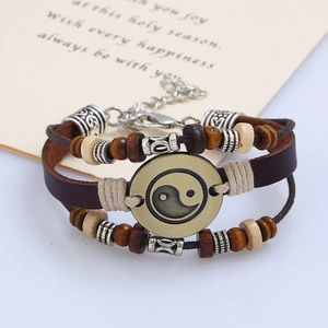 Vintage layered leather bracelet with beaded wooden accents and Yin Yang symbol pendant