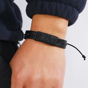 Handmade woven black leather bracelet for men featuring a rugged layered industrial design