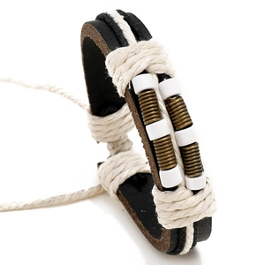 Handmade woven leather bracelet with vintage beads and bronze wire in bohemian style
