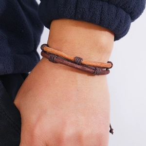 Handcrafted braided leather bracelet in dark and light brown with adjustable rope knots