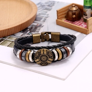 Close-up of multilayer braided leather bracelet with vintage bronze buckle and beads