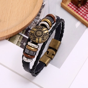 Close-up of multilayer braided leather bracelet with Nordic totem bronze charm and beads