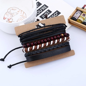 Detail view of multi-layer men's vintage leather bracelets with beads and woven cords