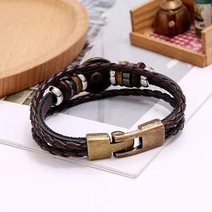 Detailed macro of multi-layer braided brown leather bracelet with antique bronze clasp