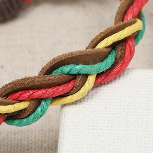 Macro shot of multi-layer braided leather bracelet showing red yellow green woven details
