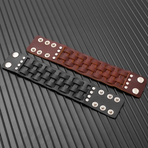 Detail of vintage multilayer leather bracelets with punk rivets and adjustable metal snaps
