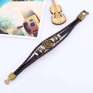 Retro multi-layer braided leather bracelet with vintage bronze pendant on white background