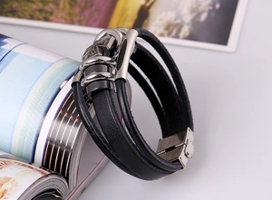 Macro detail of multi-layer black leather punk bracelet with stainless steel buckle