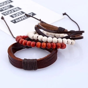 Detail view of retro 4-piece leather and wood bead bracelets set with stacked layers