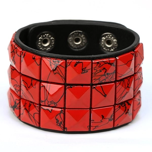 Punk wide black leather bracelet with three rows of red square studs and metal snaps