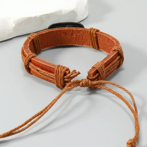 Macro shot of brown braided leather bracelet with adjustable knot cord detail