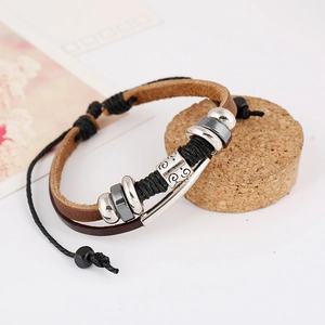 Multi-layer vintage braided leather bracelet with silver beads on a cork display