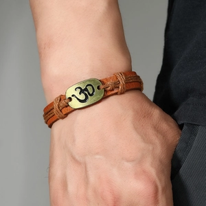 Handmade multilayer leather bracelet with Om symbol charm on male wrist for retro style