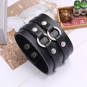 Detail of wide black leather punk bracelet with double silver rings and metal rivets