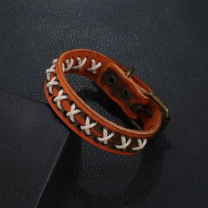 Braided orange-brown leather bracelet with white stitching and vintage bronze buckle