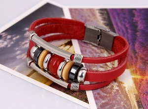 Detail of red multilayer leather bracelet with silver metal tubes and mixed beads charms