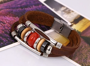 Close-up of multilayer brown leather bracelet with silver metal beads and wood accents