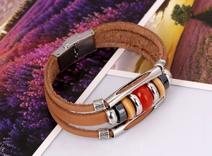 Close-up of stainless steel clasp on a brown braided leather bracelet with beads